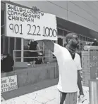  ??  ?? Darin Abston joins a group of around a dozen people protesting outside 201 Poplar demanding for the defunding the Shelby County Sheriff’s Department and reallocati­ng funds to Shelby County Schools on Saturday.