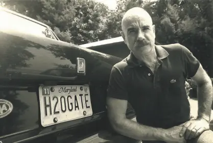  ?? Ira Schwartz / Associated Press (undated) ?? G. Gordon Liddy next to his car's license plate which translates to "Watergate." And Watergate, for Liddy, translated to jail — and remarkable subsequent success.