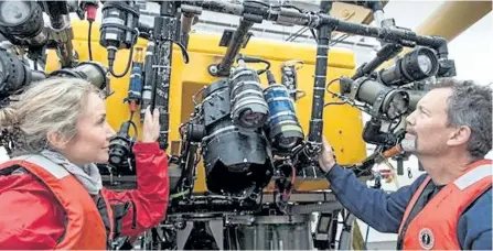  ?? OCEANS CANADA HANDOUT ?? Onboard the Martha L. Black, Robert Rangeley, right, director of Science at Oceana Canada and Alexandra Cousteau, senior Oceana advisor, inspect the ROPOS after a dive. The ROPOS is a state-of-the-art underwater robot that can collect samples and...