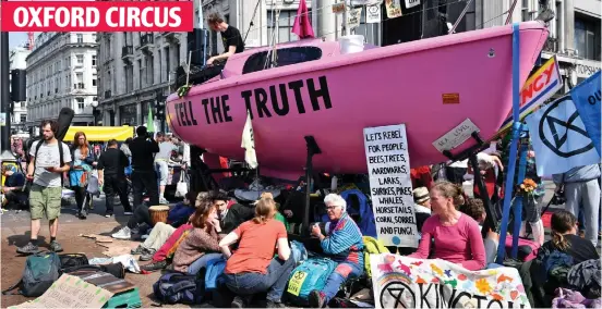  ??  ?? Floating voters: A 20ft pink yacht at the crossroads of Oxford Street and Regent Street – with protesters chained to it