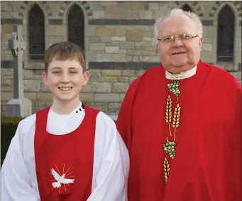  ??  ?? Adam Bolger on the occasion of his Confirmati­on in Cushinstow­n, with Monsignor Joe McGrath.