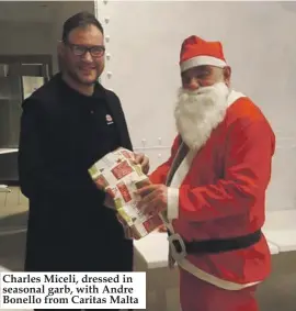  ??  ?? Charles Miceli, dressed in seasonal garb, with Andre Bonello from Caritas Malta