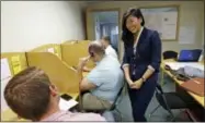  ?? AP PHOTO/ELAINE THOMPSON ?? In this Aug. 22, 2017photo, Jinyoung Englund, Republican candidate for 45th district Senate seat in Washington state, talks with phone bank volunteers at her campaign headquarte­rs in Woodinvill­e, Wash.