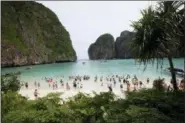  ?? SAKCHAI LALIT — ASSOCIATED PRESS FILE PHOTO ?? In this May 31, 2018, file photo, tourists walk the beach of Maya Bay, Phi Phi Leh island in Krabi province, Thailand. The American Society of Travel Agents is starting to refer to agents as ‘travel advisers’ to better describe their emerging roles as...