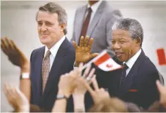  ?? WM. DEKAY / THE CANADIAN PRESS FILES ?? Nelson Mandela, with Mulroney, greets people as he arrives in Ottawa for a 1990 visit.