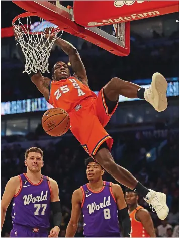  ?? JONATHAN DANIEL — GETTY IMAGES ?? Team USA’s Kendrick Nunn dunks over Luka Doncic (77) and Rui Hachimura (8) of the World team during Friday’s Rising Stars Challenge at the United Center in Chicago.