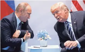  ?? EVAN VUCCI/AP ?? President Trump, with Russian President Vladimir Putin at the G-20 Summit in Germany last July, has ignored the Russian threat, a report says.