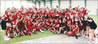  ?? MARK HUMPHREY ENTERPRISE-LEADER ?? Farmington’s 2019 senior high football team and managers posed inside the indoor training facility that is part of the new field house contained within the school’s $16 million Sports Complex. The team celebrated Friday’s 27-7 win over rival Prairie Grove to open Cardinal Stadium.