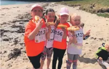  ?? ?? Above right: Wee pals Taylor, Erika, Maida and Emma enjoying some obligatory MOKRun Danish pastries after completing their ‘virtual’ junior runs on Saddell beach in 2021