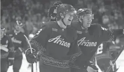  ?? JOE RONDONE/THE REPUBLIC ?? Coyotes center Barrett Hayton, left, celebrates his game-winning overtime goal with teammates, including Troy Stecher, as they defeat the Blue Jackets 3-2 on Sunday at Mullett Arena in Tempe.