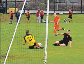  ??  ?? Arran keeper Stephen Judge makes a brave save from a sliding Irvine Vics player.