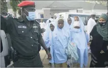  ?? SUNDAY ALAMBA — THE ASSOCIATED PRESS ?? Some of the students who were abducted by gunmen from the Government Girls Secondary School, in Jangebe, last week wait for a medical checkup after their release meeting with the state Governor Bello Matawalle, in Gusau, northern Nigeria, Tuesday.