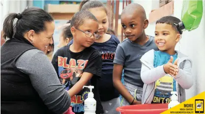  ?? TRACEY ADAMS African News Agency (ANA) ?? PRINCIPAL Chantal Braaf, Ashrudeen Samuels, 5, Isra Fataar, 4, and Mahmoud Muika, 5, and Zach de Lange, 5, at Happy Valley Daycare in Strandfont­ein wash their hands for Global Hand-washing Day. See page 8 |