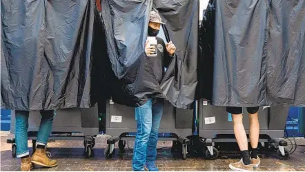  ?? JESSICA KOURKOUNIS GETTY IMAGES ?? Voters cast primary election ballots in Philadelph­ia. Seventy percent of the city’s polling places were closed as authoritie­s braced for protests over the death of George Floyd, an African-american man who died while in police custody in Minneapoli­s.