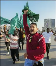  ?? ANDRE PENNER — THE ASSOCIATED PRESS ?? Fans of Saudi Arabia celebrate their team’s 2-1victory over Argentina in a World Cup Group C soccer match outside the Lusail Stadium in Qatar on Tuesday.