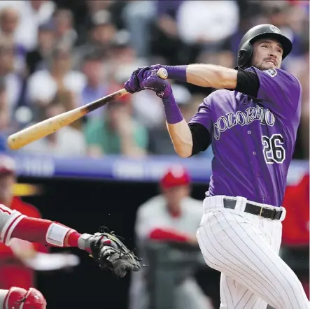  ?? DAVID ZALUBOWSKI/AP ?? Rockies outfielder David Dahl smacks an RBI triple off Philadelph­ia Phillies reliever Pat Neshek Thursday during Colorado’s 5-3 victory at Coors Field in Denver. Dahl also had a homer in the game.