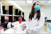  ?? JOSE M. OSORIO/CHICAGO TRIBUNE ?? Melissa Brennan, a senior scientist in research and developmen­t in the diagnostic­s division at Abbott Laboratori­es in Abbott Park, works with blood samples, testing them for antibodies to COVID-19 on Feb. 9.