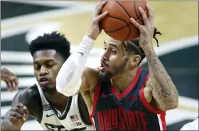  ?? DUANE BURLESON — THE ASSOCIATED PRESS ?? Ohio State guard Duane Washington Jr. drives to the basket against Michigan State guard Rocket Watts during the first half Feb. 25, in East Lansing, Mich.