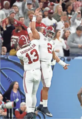  ?? GREG M. COOPER/USA TODAY SPORTS ?? Alabama quarterbac­k Jalen Hurts celebrates with backup quarterbac­k Tua Tagovailoa.