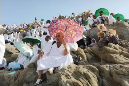  ?? Pilgrimage. Photograph: Ashraf Amra/EPA ?? Muslim pilgrims use umbrellas to protect themselves from the heat as they gather on Mount Arafat, Saudi Arabia, during the 2023 Hajj