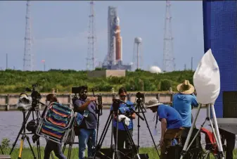  ?? Chris O’Meara / Associated Press ?? Photograph­ers pack up their gear in Cape Canaveral after NASA canceled the scheduled launch of its new moon rocket. For the second time in a week, a fuel leak foiled the liftoff.