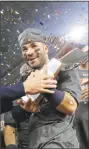  ?? David J. Phillip / Associated Press ?? Jose Altuve holds the championsh­ip trophy after Game 7 of the American League Championsh­ip Series against the Yankees.