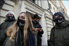  ?? Natalia Kolesnikov­a / Getty Images ?? Memorial Internatio­nal’s supporters, wearing face masks with the logo of Russia’s rights group, stand outside Russia’s Supreme Court on Tuesday, after a prosecutor’s request to dissolve Memorial Internatio­nal, the country’s most prominent rights group, for allegedly violating the controvers­ial law on “foreign agents,” in Moscow