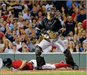  ?? MICHAEL DWYER / THE ASSOCIATED PRESS ?? White Sox catcher Kevan Smith, top, looks to the runners after the force-out on the Red Sox’s Xander Bogaerts, left, on a ground ball by Mookie Betts during the fifth inning Aug. 4 in Boston.