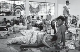  ?? Ed Jones / AFP via Getty Images ?? Evacuees displaced by the Taal volcano eruption rest in their room at a government complex used as an evacuation center in Tagaytay, Philippine­s.