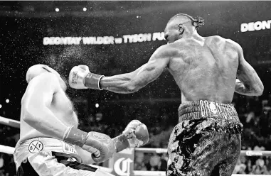  ??  ?? Deontay Wilder knocks Tyson Fury down during the 12th round resulting in a draw during the WBC Heavyweigh­t Champioins­hip at Staples Center in Los Angeles, California. — AFP photo
