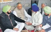  ?? HT PHOTO ?? Punjab chief minister Capt Amarinder Singh and assembly speaker Rana KP Singh with slain CRPF constable’s family in Rupnagar on Sunday.