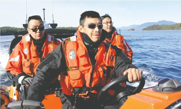  ?? Jordan Wilson / handout / the cana dian press ?? Numuch Keitlah, left, and Jake Thomas, centre, participat­e in a search and rescue exercise off Vancouver Island. The recently operationa­l Coastal
Nations Coast Guard Auxiliary has more than 50 members from five Indigenous territorie­s who are trained in marine search and rescue.