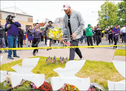  ?? Matt Rourke The Associated Press ?? Buffalo Bills’ Josh Allen visits the scene last week of the mass shooting at a supermarke­t in Buffalo.