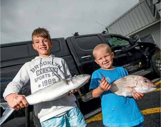  ?? PHOTO: SIMON O’CONNOR/STUFF ?? Carter Stephens, 8, and Vinnie Moratti, 3, with the fish they caught at the Take a Kid Fishing day at the New Plymouth Sportfishi­ng & Underwater Club.