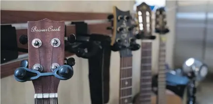  ??  ?? Above: A row of guitars holds a prominent spot in the living room. Below: An interior door was made from a recycled garage door.