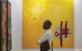  ??  ?? A visitor taking in the work of Amadou Sanogo at the Retro Africa Gallery booth