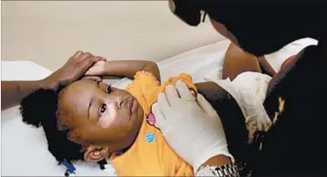  ?? CAROLYN COLE/LOS ANGELES TIMES ?? Kendra Curtis, 1, gets a check at the Capitol City Family Health Center in Baton Rouge, La. In Louisiana and 779 mostly rural counties, Medicaid and CHIP provide health coverage for many children in counties that voted for Donald Trump.