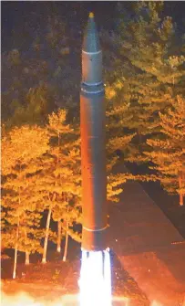  ?? Yonhap ?? A North Korean Hwasong-14 interconti­nental ballistic missile is launched in this photo released by the North’s state-run Korean Central News Agency, Saturday. The missile was launched from Chagang Province in northern North Korea, at 11:41 p.m., Friday.