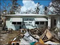  ?? The New York Times/KEVIN HAGEN ?? A warning to looters is painted on the side of William Smith’s house in Marathon, Fla., on Wednesday. Damage to the area was extensive, with flooding still a problem.