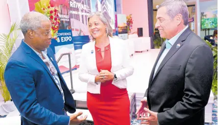  ?? RUDOLPH BROWN/ PHOTOGRAPH­ER ?? Ricky Cardenas (right), co-owner of the RE/MAX Caribbean and Central America Region, speaks with O’Neil Kirlew (left), a RE/MAX franchisee, and Hannah Rico Fletcher, RE/MAX Costa Rica’s regional director, at the RE/ MAX Jamiaca Premier Real Estate conference and expo held at The Jamaica Pegasus hotel in New Kingston on Sunday.