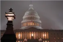  ?? Associated Press ?? ■ The U.S. Capitol in Washington is shrouded in mist Friday night.