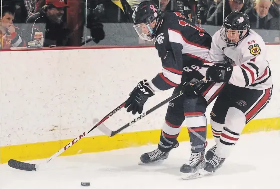  ?? LANCE ANDERSON/METROLAND ?? The Lakefield Chiefs' Carson Hartwick and Port Hope Panthers' Austin Veleke battle behind the net during the first period of Game 7 of the PJHL East Conference Final against the Port Hope Panthers in Lakefield on Sunday afternoon.