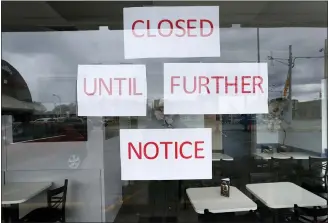  ?? PAUL SANCYA — THE ASSOCIATED PRESS ?? Like most restaurant­s across the country, Vasi’s Cafe is closed in St. Clair Shores, Mich., due to the coronaviru­s pandemic.