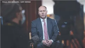  ?? Picture: NCA NEWSWIRE / GARY RAMAGE ?? IN DEEP: Treasurer Josh Frydenberg is forecastin­g a deficit of $185bn for this financial year.