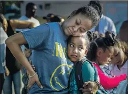  ?? Irfan Khan Los Angeles Times ?? LILIAN LOPEZ, left, and her daughter Leah Eaton, 7, say their goodbyes before the third-grader starts classes at Baldwin Hills Elementary School.