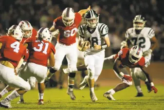  ?? D. Ross Cameron / Special to The Chronicle ?? Sacred Heart Cathedral quarterbac­k Cian Dowling looks for running room during his team’s 26-21 victory over St. Ignatius at Kezar Stadium on Oct. 5.