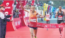  ?? PTI ?? Ethiopia’s Amedework Walelegn gestures as he crosses the finish line on Sunday.