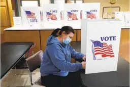  ?? PAUL SANCYA AP ?? Angela Beauchamp fills out an absentee ballot in Garden City, Mich., last year. Republican­s across the country have enacted new limits on mail voting.