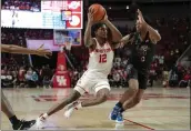  ?? KEVIN M. COX — THE ASSOCIATED PRESS ?? Houston guard Tramon Mark (12) drives around Memphis guard Elijah McCadden (0) during the second half on Sunday in Houston.