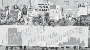  ?? Trent Nelson / Salt Lake Tribune via Associated Press ?? Demonstrat­ors in Salt Lake City protest Monday against scaling back two national monuments.